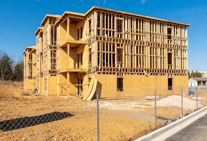 a close-up of temporary chain link fences enclosing a construction site, signaling progress in the project's development in Brea